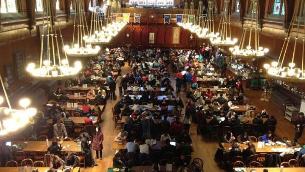 Precaution ... Harvard University students gather in the Annenberg Hall after being evacuated from campus buildings following unconfirmed reports that explosives had been planted on university grounds.