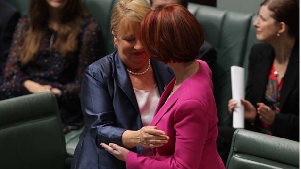 Disability Reform Minister Jenny Macklin and Prime Minister Julia Gillard embraces after introducing the NDIS in Parliament.