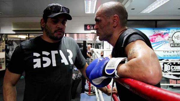 Greg Inglis chats yesterday with his mate Anthony Mundine, who is preparing for a fight on December 8.