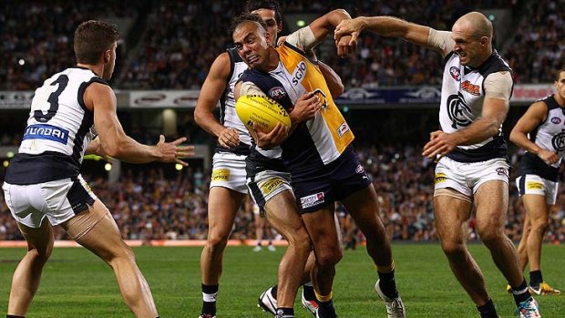 Marc Murphy (left) and Chris Judd (right) come to grips with Daniel Kerr.