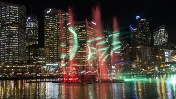 Water fountains and lasers work in tandem at Vivid Sydney in Darling Harbour.
