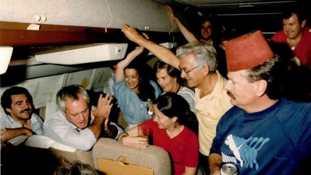Bob and Hazel Hawke (centre right) with travelling minstrels aboard the old VIP Boeing 707. The late Paul Lyneham (second from left), leads the chorus.
