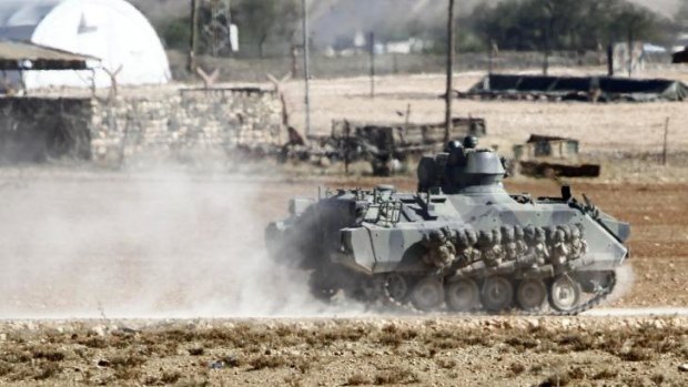 A Turkish tank manoeuvres near the Turkish-Syrian border. Turkey is now allowing Kurdish forces to be reinforced in Kobane through its border with Syria.