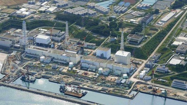 An aerial view shows the Tokyo Electric Power Co.'s (TEPCO) tsunami-crippled Fukushima Daiichi nuclear power plant and its contaminated water storage tanks (top) in Fukushima.