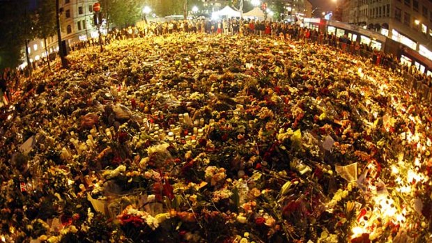 Sea of flowers ... thousands have come out in Oslo to remember the victims of twin attacks.