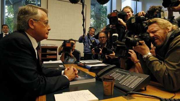 Treasurer Wayne Swan poses for the media with the 2013 budget at Parliament House.