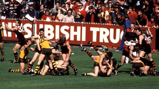 Andrew Tate is just to the right of the fans in this photo, getting the best possible view of shennaigans during the 1985 grand final.
