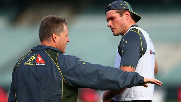 Wallabies assistant coach Andrew Blades has a word to captain Ben Mowen during a training session in Perth on Friday.