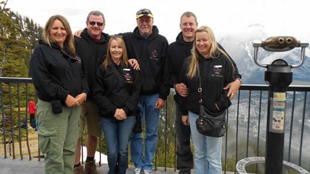 The group wearing their hoodies in Alaska.