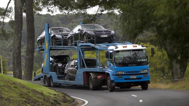 Police remove vehicles belonging to Kim Dotcom from his home during the January raid.