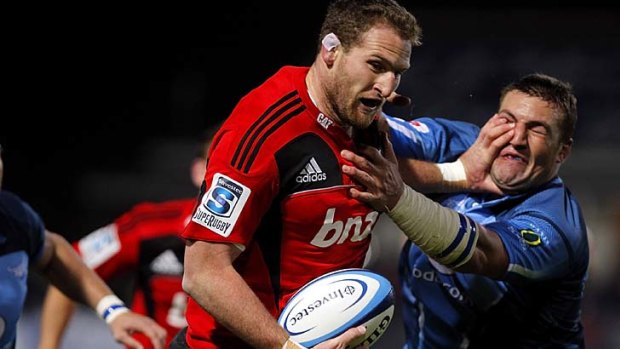 Kieran Read of the Crusaders is tackled by Dean Greyling of the Bulls.