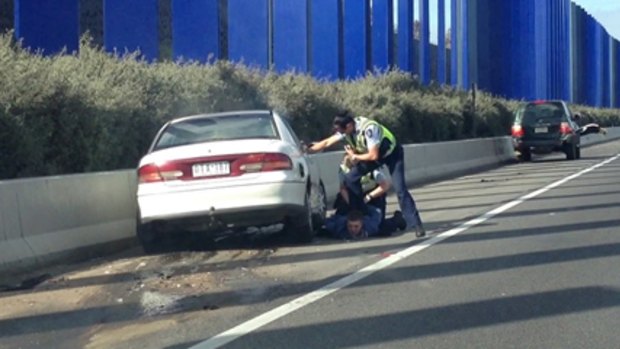 A man is taken into custody on the Hume Freeway in Melbourne’s outer north after he crashed into a blockade of people’s cars set up by police.