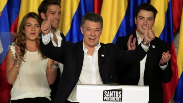Peace platform: Colombian President Juan Manuel Santos celebrates after winning a second term.