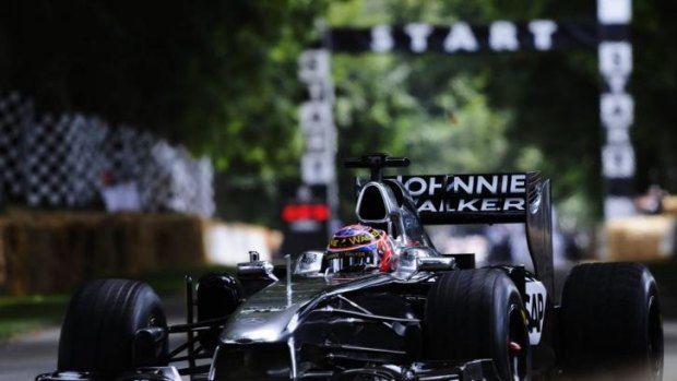 Jenson Button drives the McLaren MP4/26 during the Goodwood Festival of Speed at Goodwood House on Saturday.