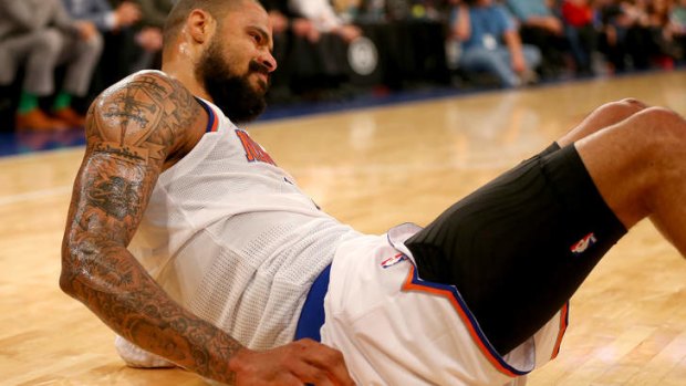 Knicks centre Tyson Chandler struggles to get up after colliding with Kemba Walker of the Charlotte Bobcats in the first quarter at Madison Square Garden.