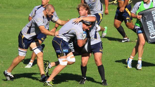 Ben Mowen pushes through with Scott Fardy during Brumbies' training on Wednesday.