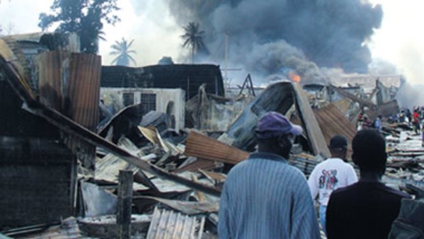 Fuelling friction in the Solomons...shops blaze in Honiara's Chinatown after a night of rioting in 2006