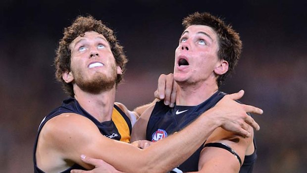 Tyrone Vickery comes to grips with Carlton's Matthew Kreuzer. The Richmond tall is yet to be cleared to play this week.