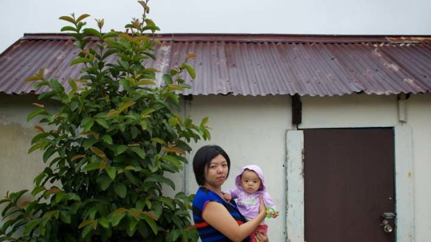 Sent home &#8230; Elly Sugianto with her 8-month-old daughter Zara. Elly was dismissed by her employer, Commonwealth Bank, after returning from maternity leave.