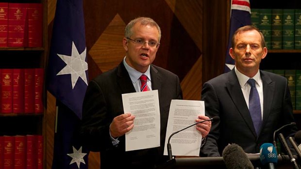 "Australian aid should never be a free gift": Opposition Leader Tony Abbott (right), with immigration spokesman Scott Morrison has expressed concern  about Labor's deal with Papua New Guinea.