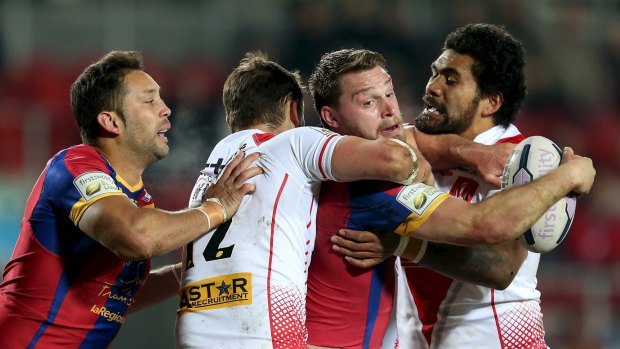 World series: former Panthers and Roosters forward Mose Masoe of St Helens wraps up Catalans' Elliott Whitehead.