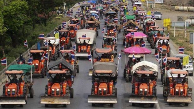 Farmers drive their tractors and other farming vehicles in Ang Thong province, towards Bangkok.