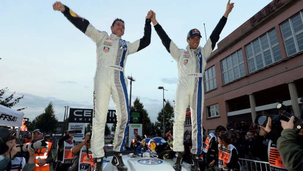 Sebastien Ogier, right, and co-driver Julien Ingrassia celebrate after winning their world champion title.
