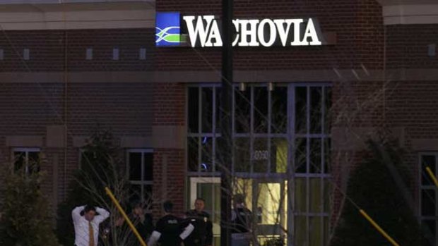 One of the hostages is led from the bank in Cary, North Carolina.
