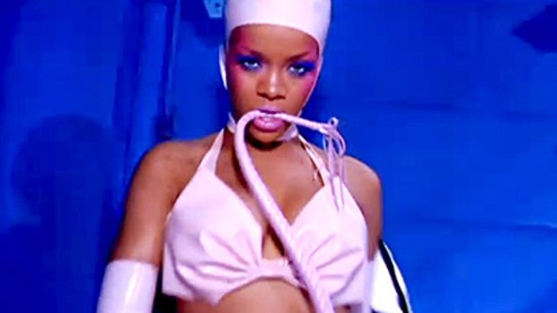 Rihanna is seen sucking a banana and leading Perez Hilton around on a dog leash in the clip.