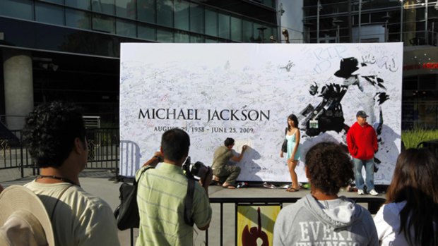 People gather outside the Staples Centre, where there will be a memorial service for Michael Jackson.