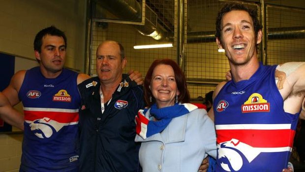 True colours: Julia Gillard with Western Bulldogs players Brian Lake and Robert Murphy, and coach Rodney Eade, in 2010.