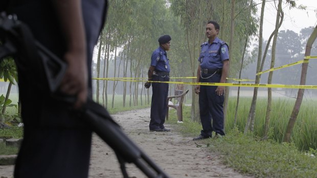 Bangladeshi security officers last Sunday stand by the site where a Japanese national, Kunio Hoshi was killed at Mahiganj village in Rangpur district, 300 kilometres north of Dhaka.