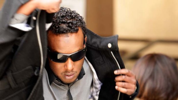 Abdi Farah, outside Melbourne Magistrates Court, is accused of being involved in attacks on two taxi drivers.