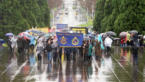 Vietnam veterans march to the 50th anniversary remembrance service at the Shrine.