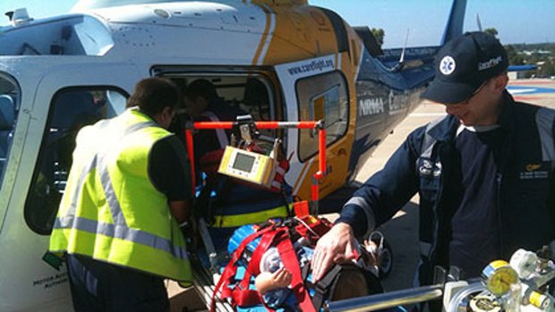 Paramedics load the injured boy onto the CareFlight helicopter.
