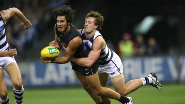 Troy Menzel is wrapped up by Jed Bews on Friday night