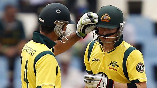 Century partnership ... former captain Ricky Ponting fixes his skipper Michael Clarke's helmet.