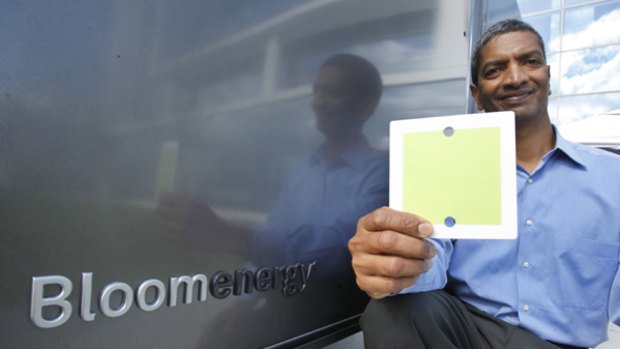 K.R. Sridhar, co-founder and CEO of Bloom Energy, holds up a fuel cell  in front of Bloom Energy power servers at eBay offices in San Jose, California.