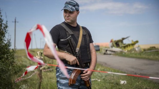 A member of a local militia guards remnants of Malaysia Airlines flight MH17 during a visit by monitors from the Organisation for Security and Cooperation in Europe on the weekend.