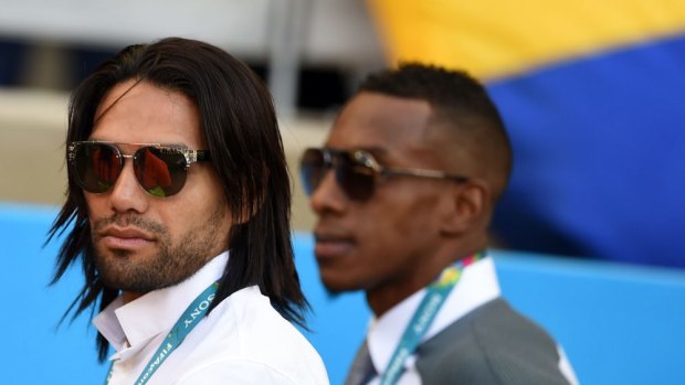 Colombia's injured striker Radamel Falcao (left) supports his national team from the sideline during the match against Greece.