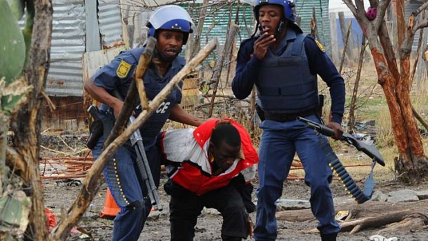 Reminiscent of the apartheid era ... South African police quell miners at Lonmin's platinum mine.