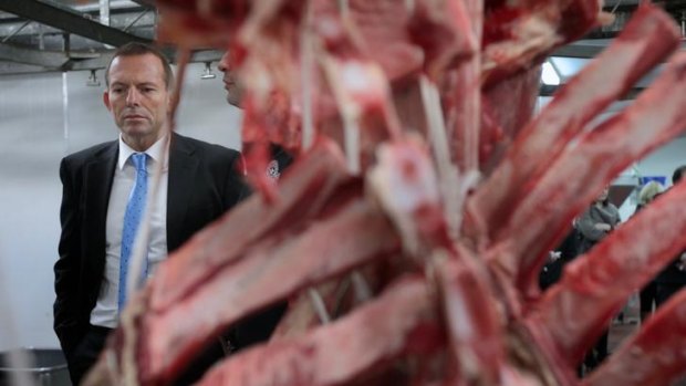 Rib roast: Tony Abbott at a butcher's shop in Canberra. A planned visit to another butcher had to be cancelled.