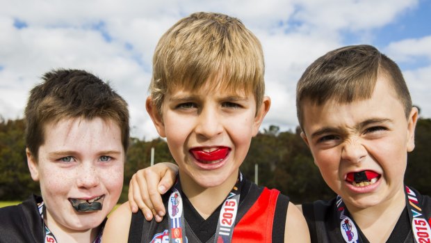 Conor Ferron, 7, James Rudzis, 8 
Jairus Brealey, 8. (L to R) were wearing mouthguards when they played at a gala day to mark the end of the AFL Auskick season at Waratah Park Reserve, Sutherland.