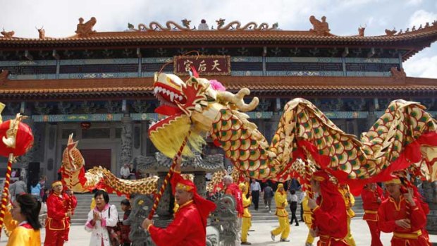 Bang, bang, bang: Firecrackers, loud drums and a lot of other noises help scare off the evil spirits at the opening of a new temple in Footscray.