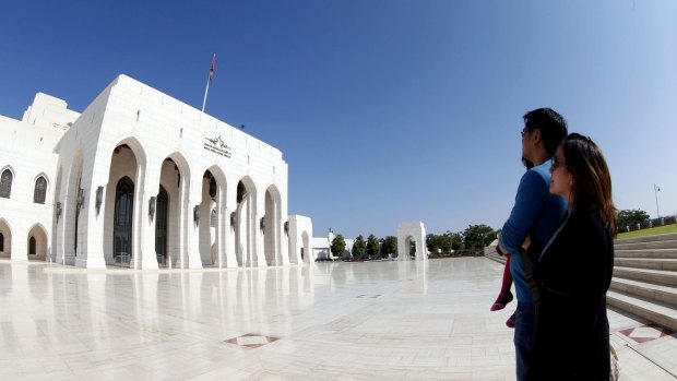 Tourists stand in front of the Royal Opera in the Omani capital Muscat.