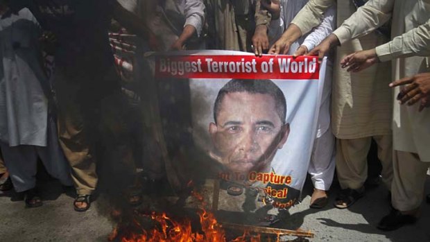 Pakistani activists burn an image of US President Barack Obama and shout anti-American slogans in the city of Multan.