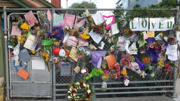 Tributes adorn a fence on Greeves Street, near the site of Tracy Connelly's memorial.