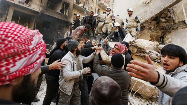 Down and out: Members of the Free Syrian Army remove a body from rubble. The power of the Western-backed group is waning as new rivals emerge.