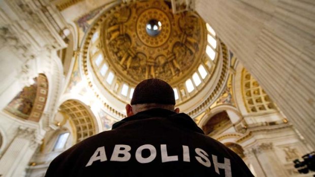 Moral highground ... a protester stands beneath the dome inside St Paul's Cathedral in London.