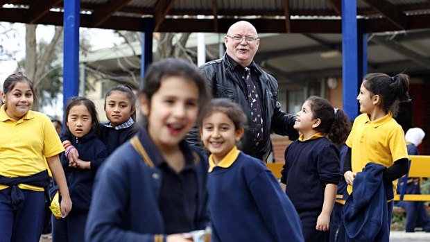 Meadow Heights Primary School principal Kevin Pope with some of his students. Pope believes NAPLAN testing is an 'obscene waste of public funds'.